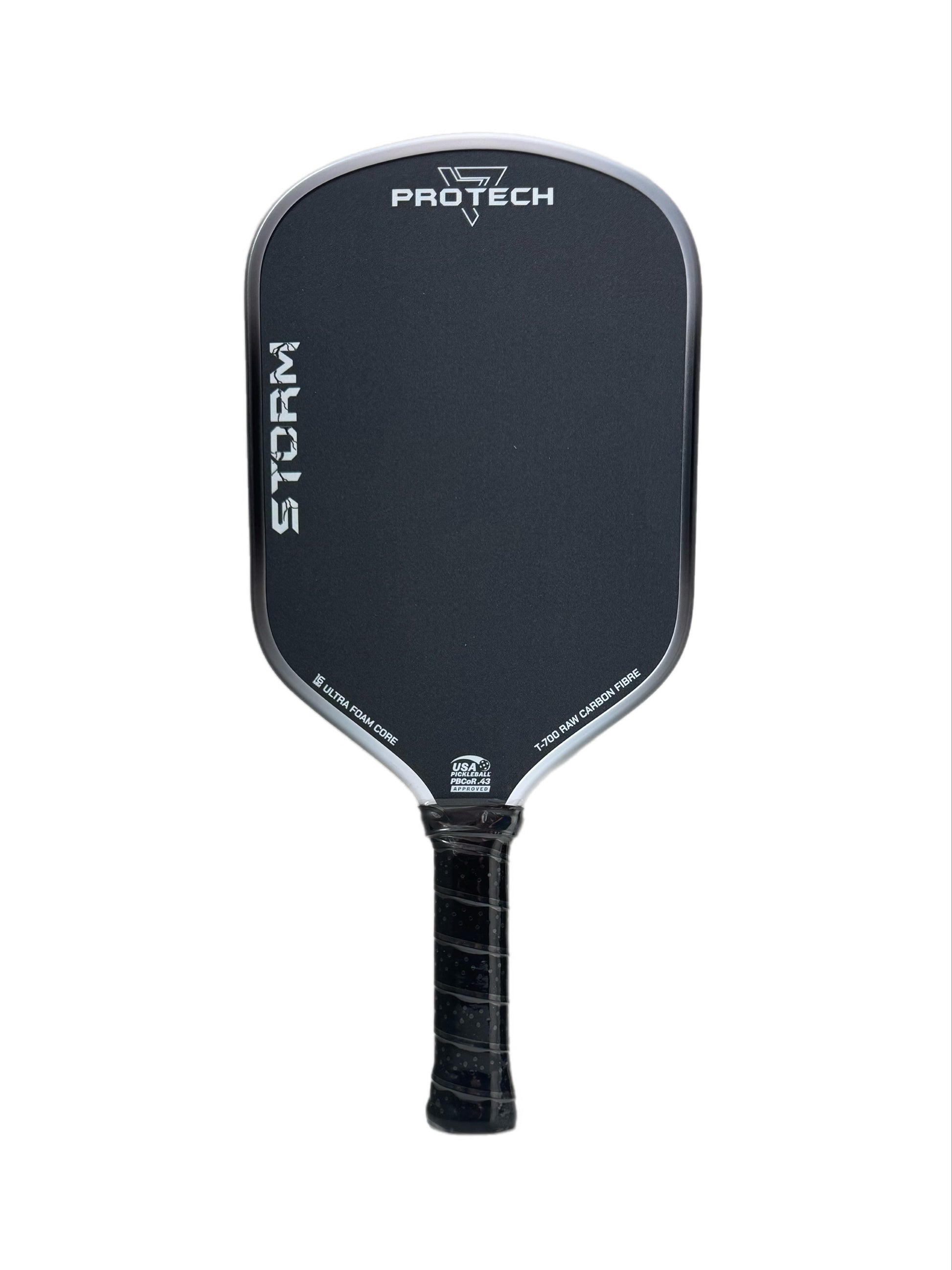 A black pickleball paddle with a textured grip handle, featuring the PROTECH brand name and STORM model printed in white on the paddle face, set against a plain white background.